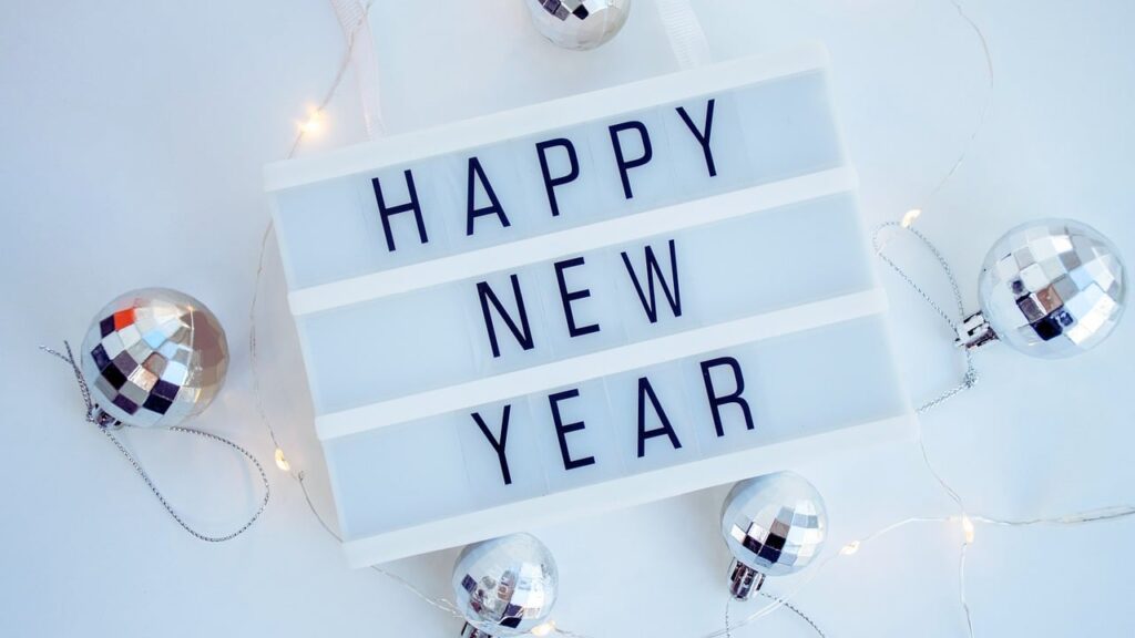 Happy New Year Sign with Silver Ornaments
