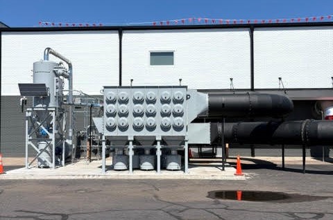 Integrated dust collection and source capture equipment serving an aircraft manufacturing training facility.
